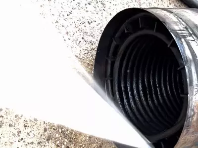 Old burst heating coil from Nilfisk Contractor pressure washer being pressure tested to find the leak.